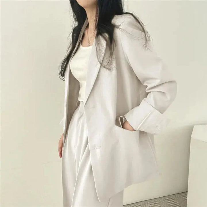 Women's versatile two-piece set, combining a sleek tailored blazer with relaxed fit professional trousers.