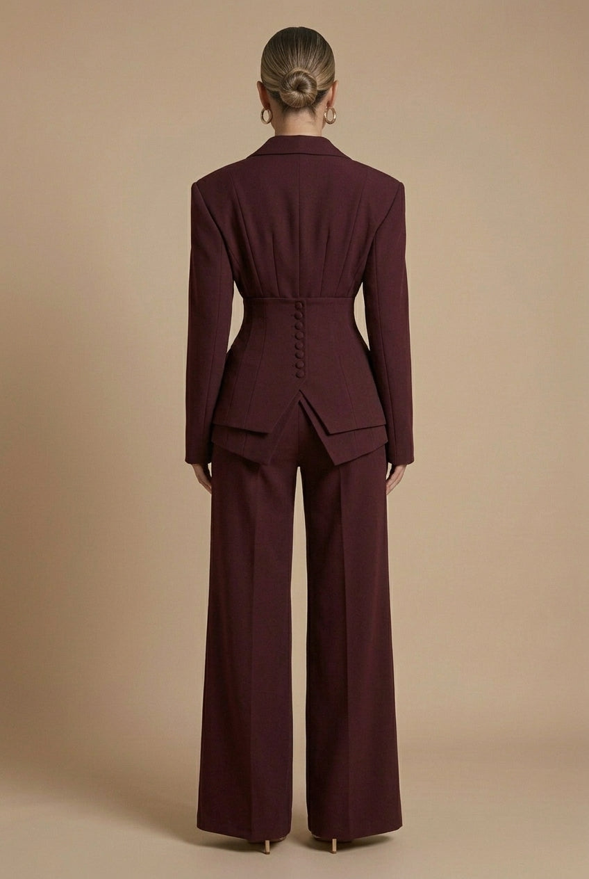 Professional women's power suit: tailored two-piece set featuring a peaked lapel blazer and wide-leg trousers.