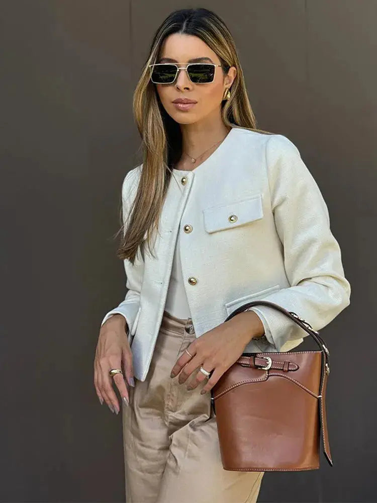 Elegant women's textured cropped button-up jacket. Chic outerwear for versatile fashion.