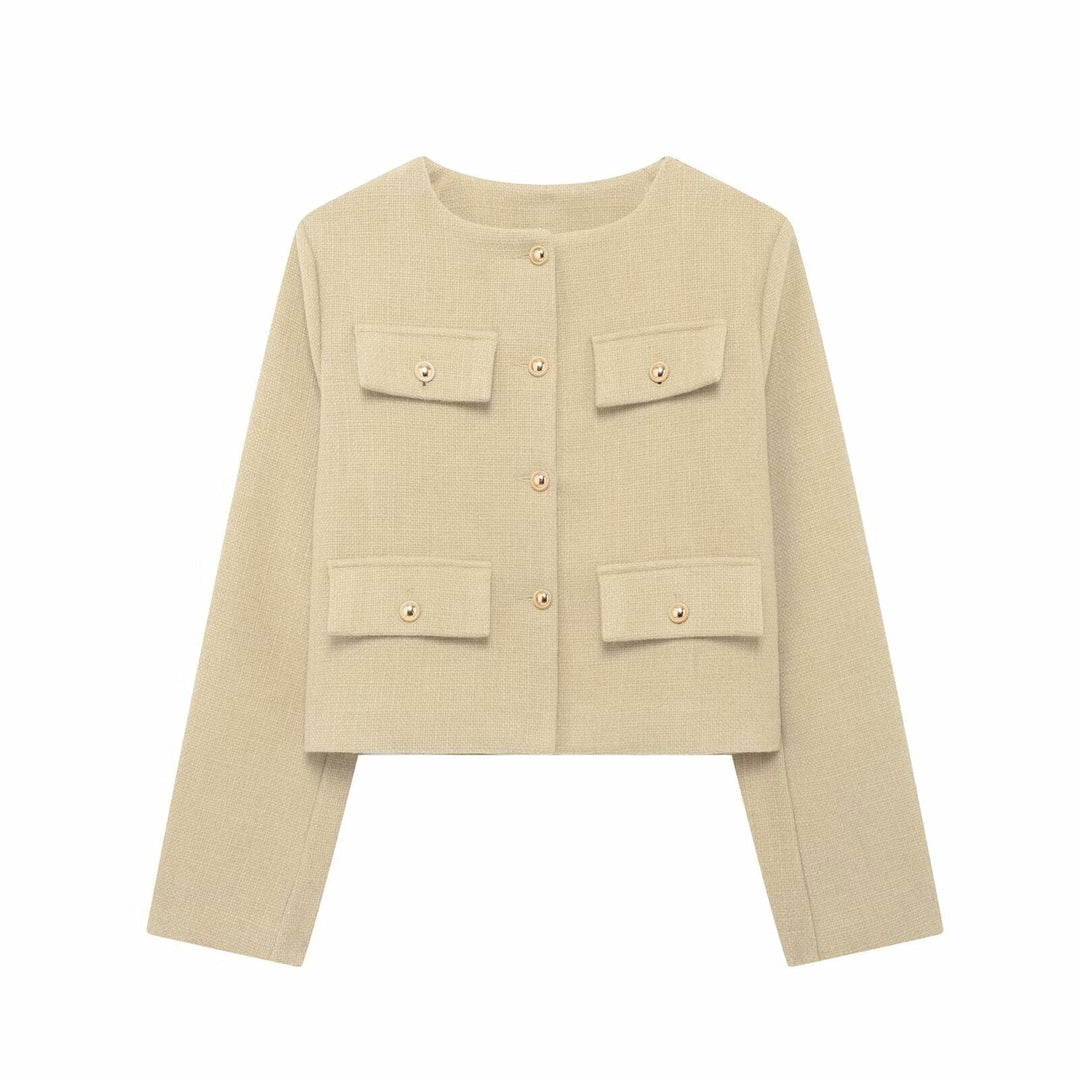 Woman in a textured cropped button-up jacket, styled for everyday elegance and versatility.