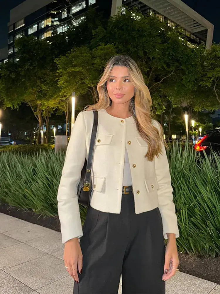Women's cropped button-up jacket paired with a skirt, showcasing chic everyday elegance.