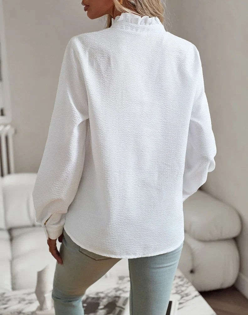 Professional workwear blouse for women; elegant textured stripes, ruffled collar, & long sleeves. Office chic.