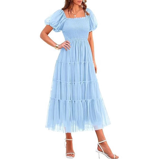 Smocked elegant tiered maxi dress with puff sleeves. Women's wedding guest & special occasion formal wear.