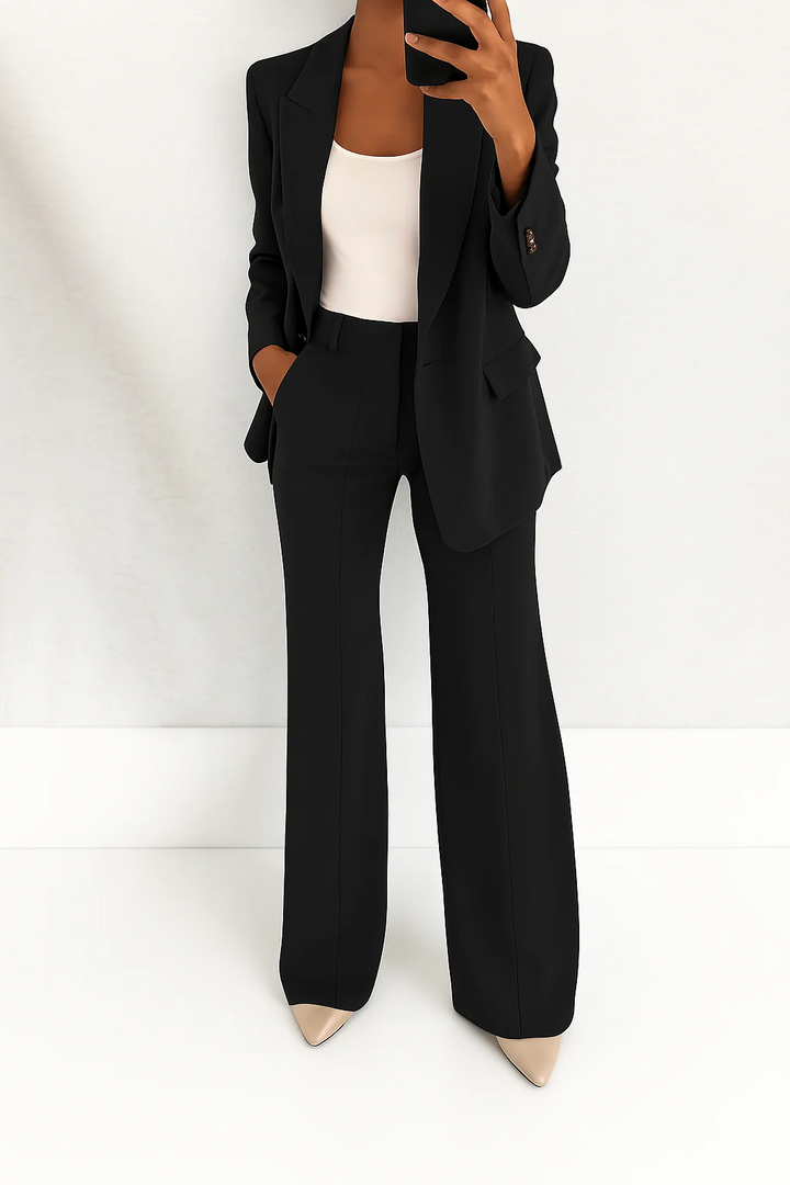 Modern formal women's two-piece suit set with a tailored blazer and straight-leg trousers for business.