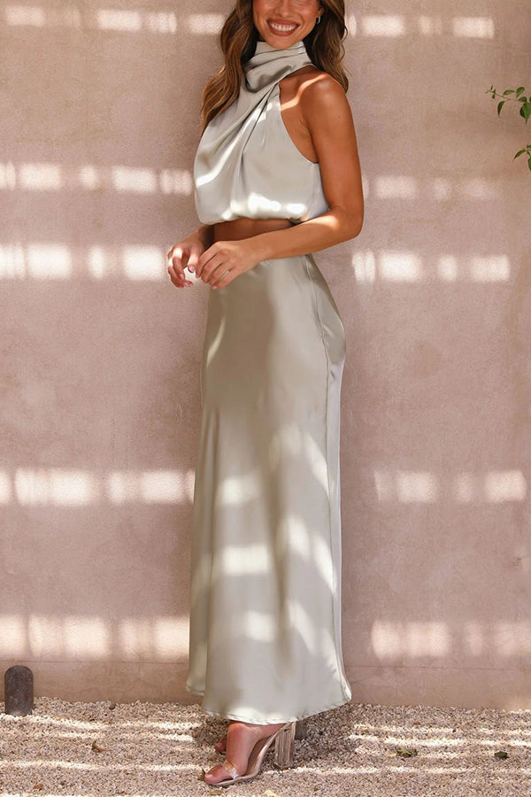 Women's elegant evening wear two-piece set featuring a halter neck top & flowing skirt.