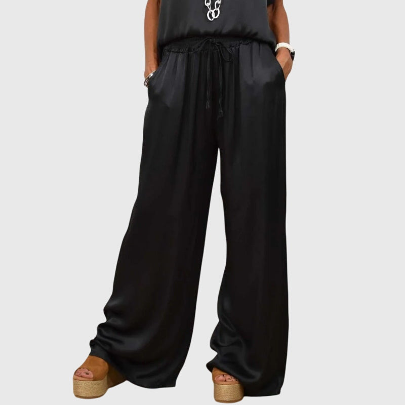 Elegant women's two-piece set of comfortable loungewear including a top and wide-leg pants. Casual chic style.