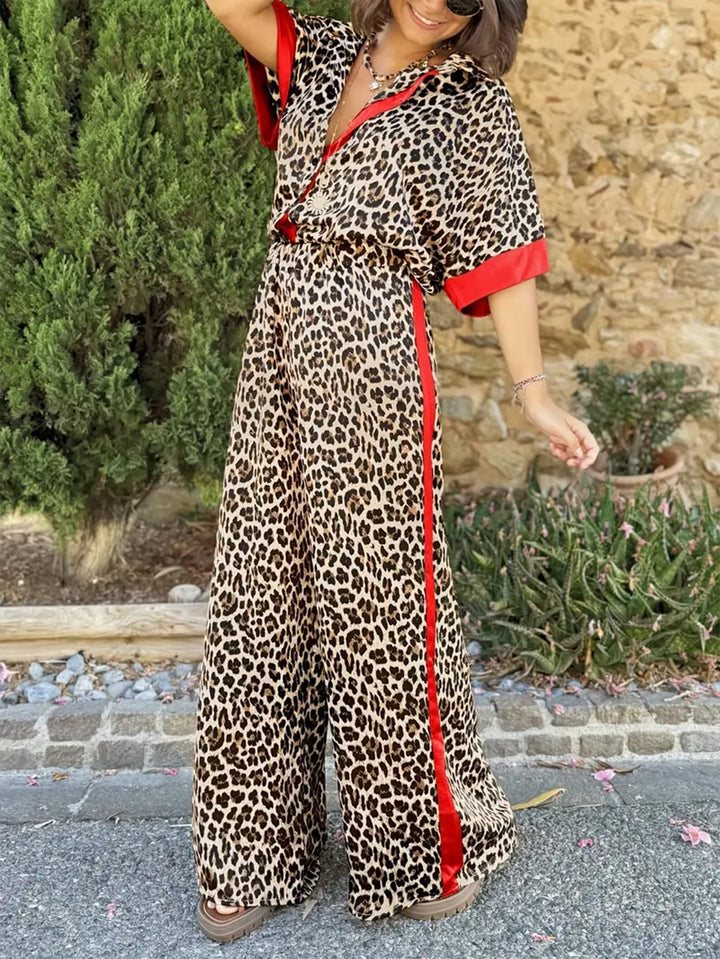 Red women's elegant two-piece set, featuring a stylish collared top & flowy wide-leg trousers. Casual chic.