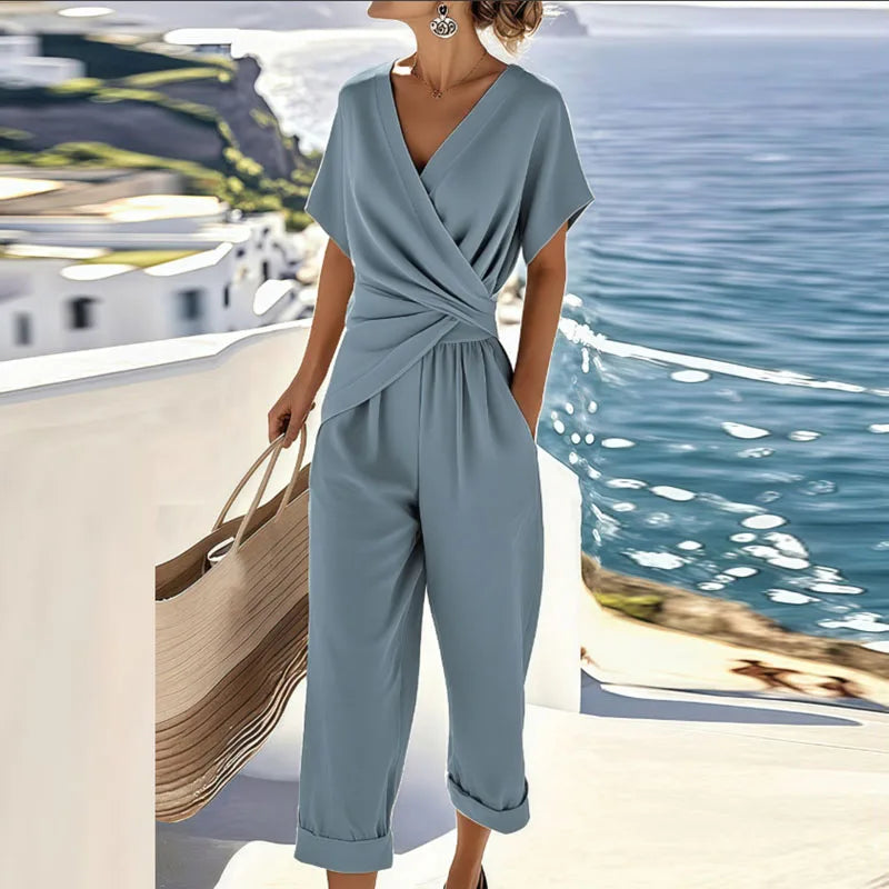 Coordinated women's wrap top and straight-leg trousers two-piece set, ideal for elegant spring/summer fashion.