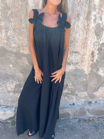 Women's flowy U-neck maxi dress with elegant bow straps, showcasing graceful movement for summer.