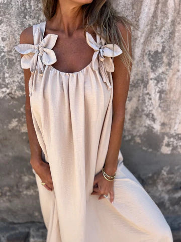 Full-length view of a women's elegant U-neck maxi dress with bow straps, great for evening wear.