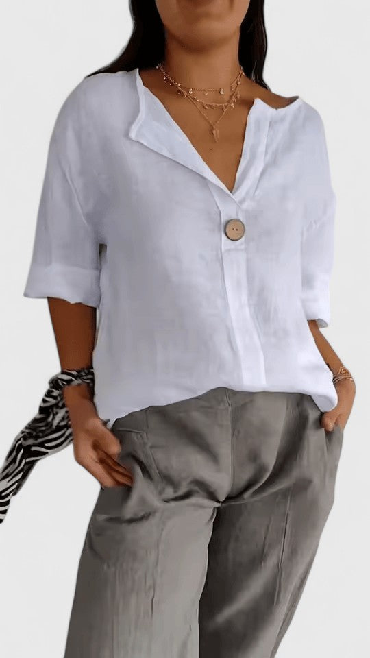 Soft, loose-fit women's V-neck blouse with stylish knot detail, great for summer comfort and chic style.