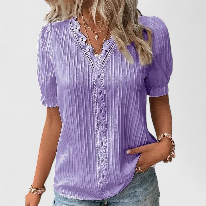 Relaxed fit women's V-neck blouse featuring unique hollow lace sleeves, a versatile summer fashion piece.