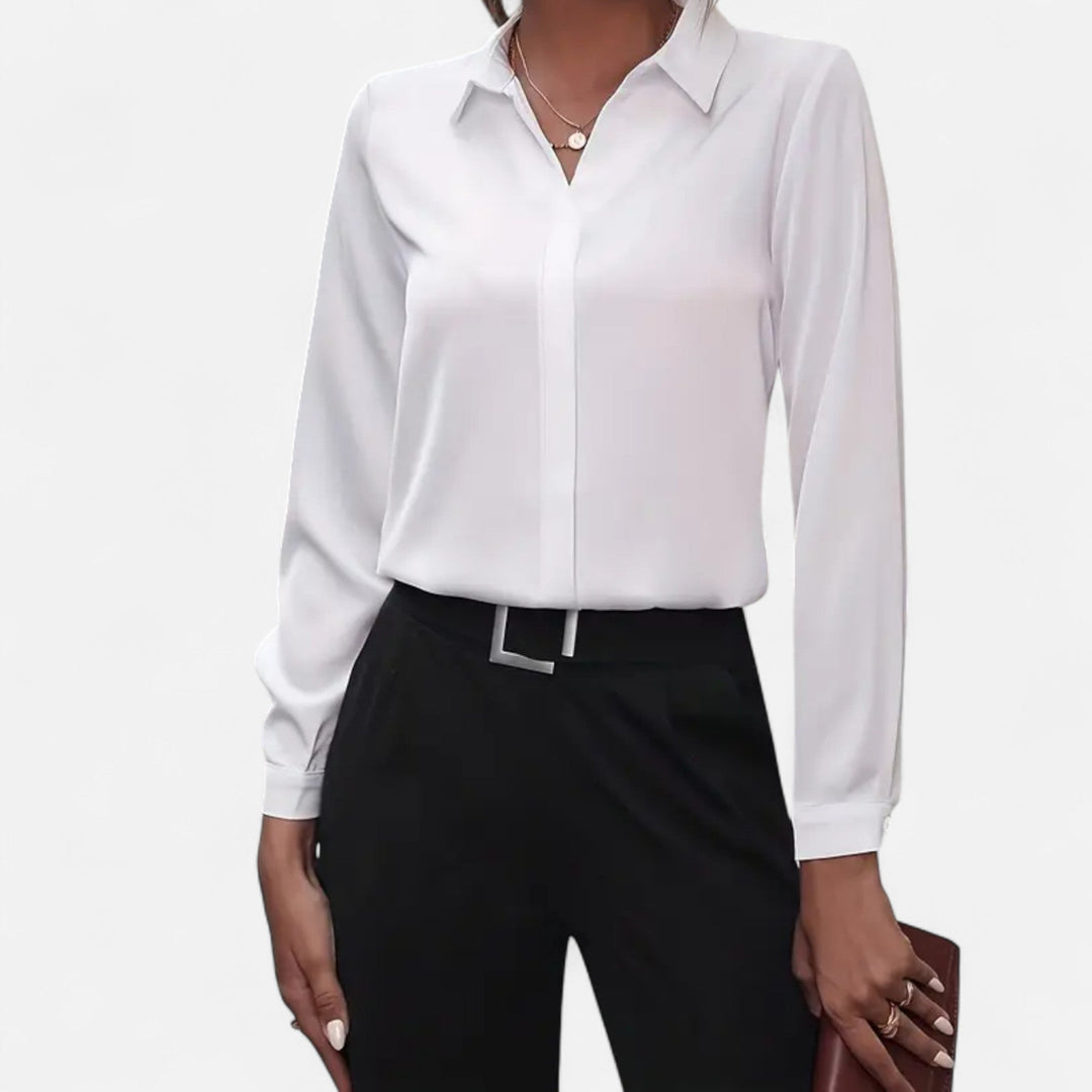 Refined women's elegant blouse with V-neck and button details, showcasing sophisticated style.