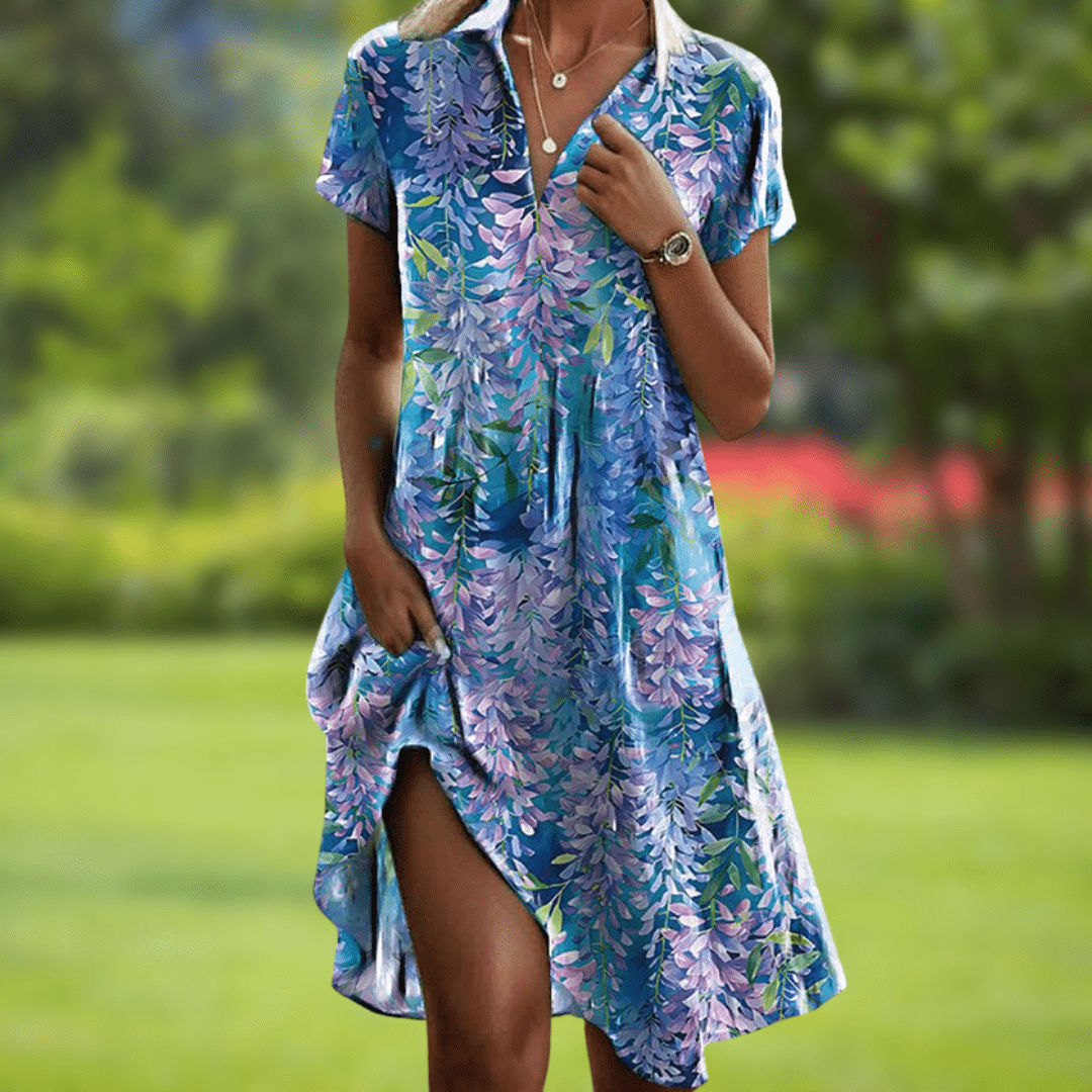 Close-up of a women's elegant V-neck floral print dress, showcasing intricate patterns and soft, flowy fabric.