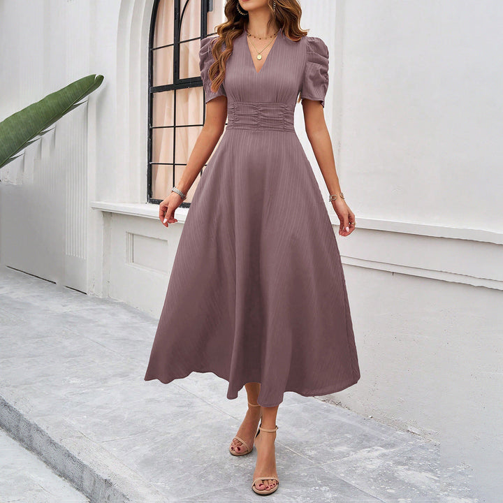 Women's elegant fit & flare midi dress. Features a flattering V-neck, chic puff sleeves, and a ruched waist.