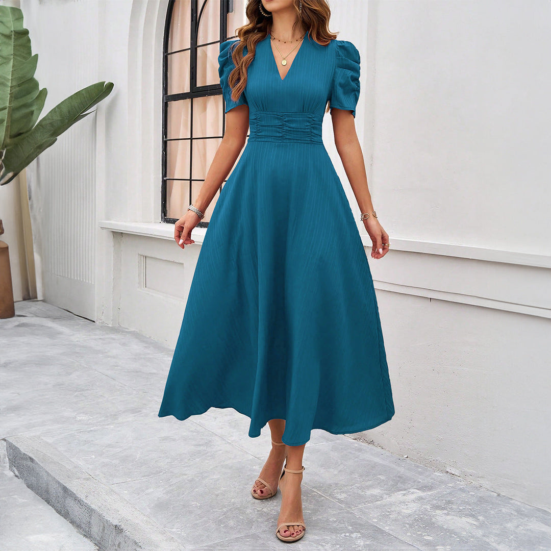 Elegant women's V-neck midi dress featuring trendy puff sleeves, a flattering ruched waist, and fit & flare design.