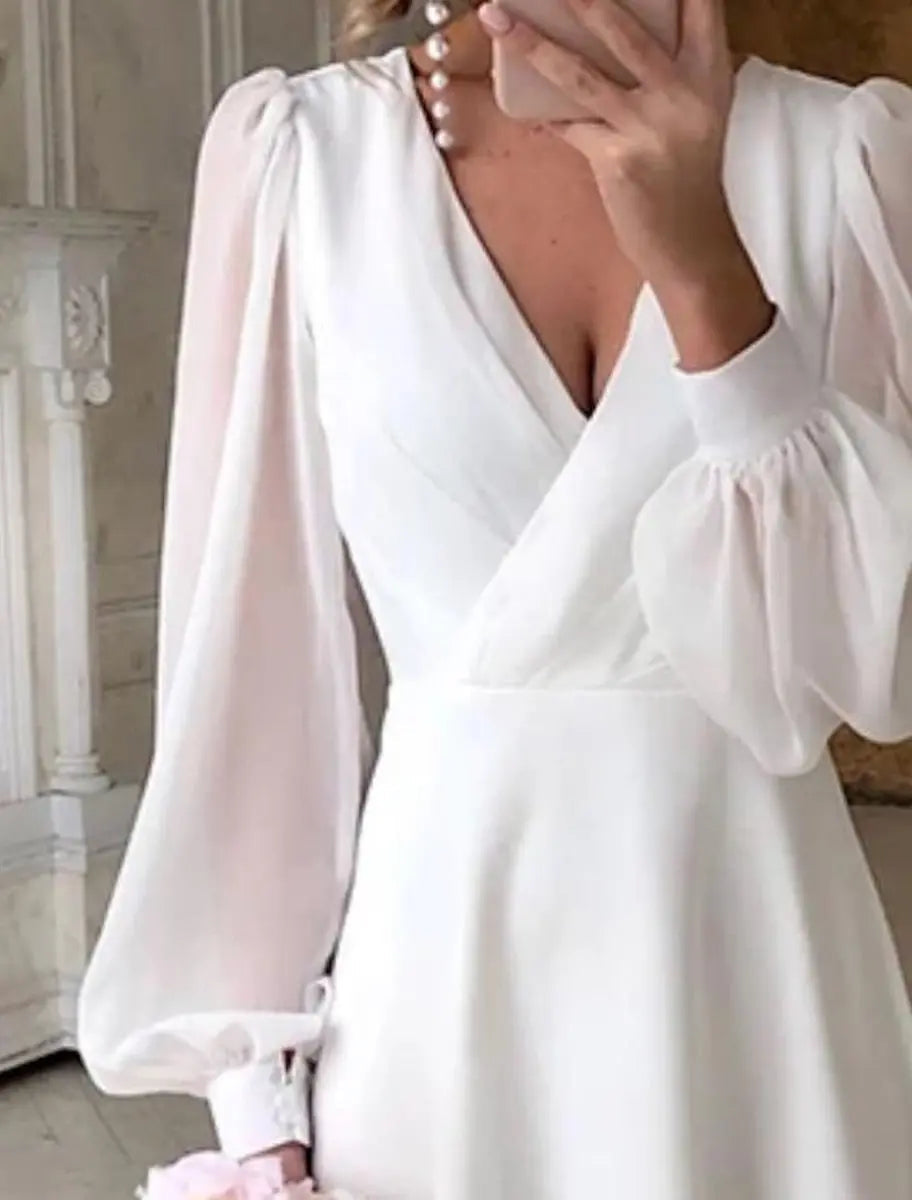 Timeless white A-line midi bridal dress with V-neck & puff long sleeves, ideal for special occasion or wedding guest.