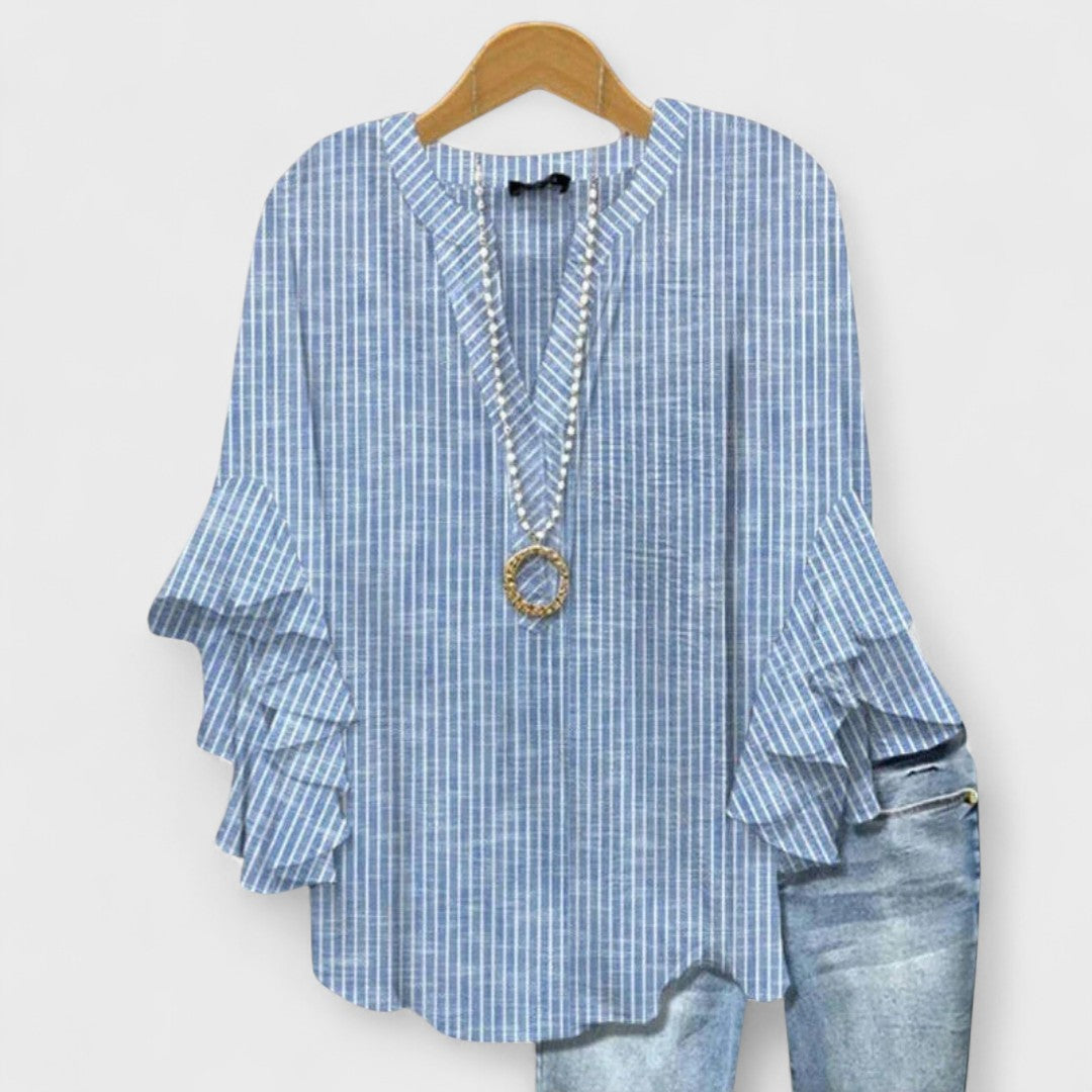 Patterned women's V-neck blouse with delicate ruffle sleeves, a versatile fashion top.