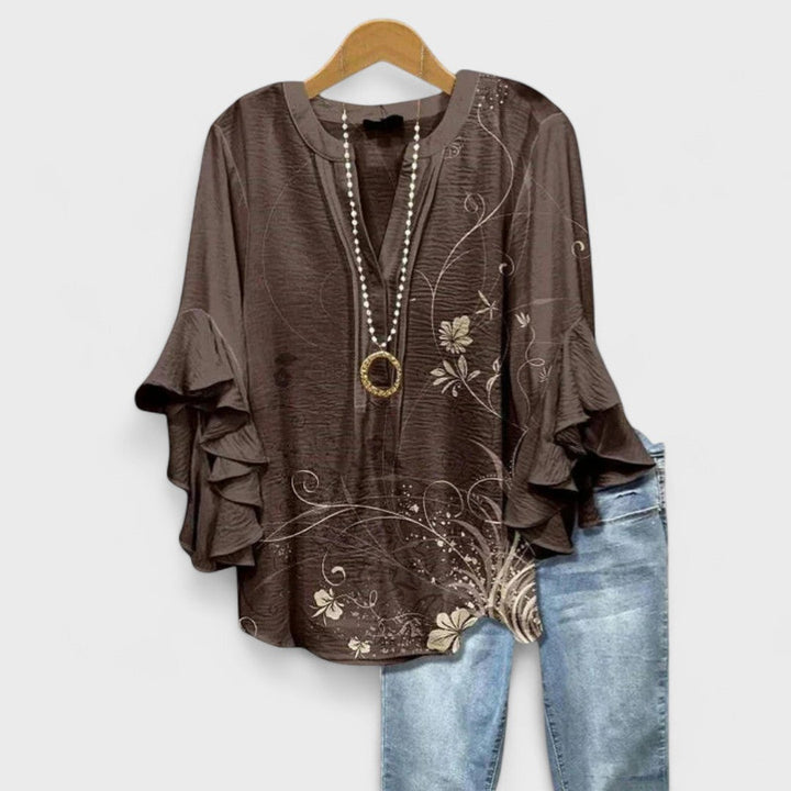 Stylish V-neck women's blouse featuring graceful ruffle sleeves, suitable for elegant casual or office wear.