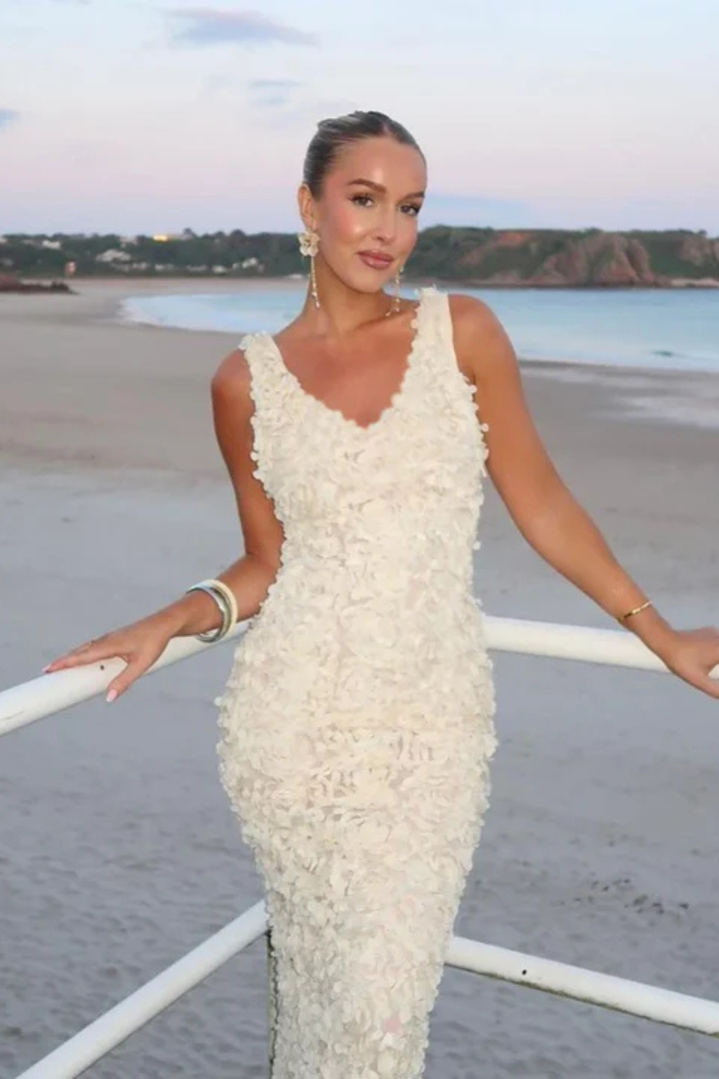Sophisticated women's V-neck sleeveless floral textured dress, a fitted and flattering formal wedding guest attire.