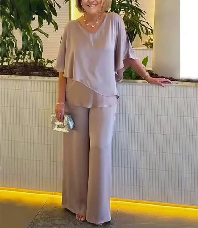 Chic women's matching V-neck top and wide-leg pants set, offering a comfortable and elegant summer attire.