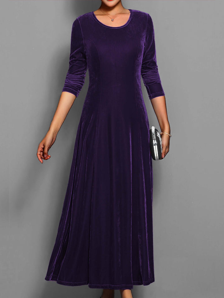 Women's crew neck, long-sleeve velvet midi dress. Elegant formal wear suitable for parties & winter fashion.