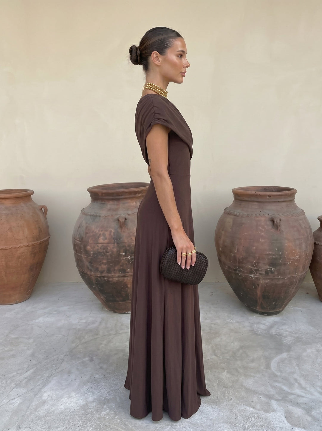 Women's elegant off-shoulder pleated maxi dress, comfortable & flowing occasion wear, available in brown.