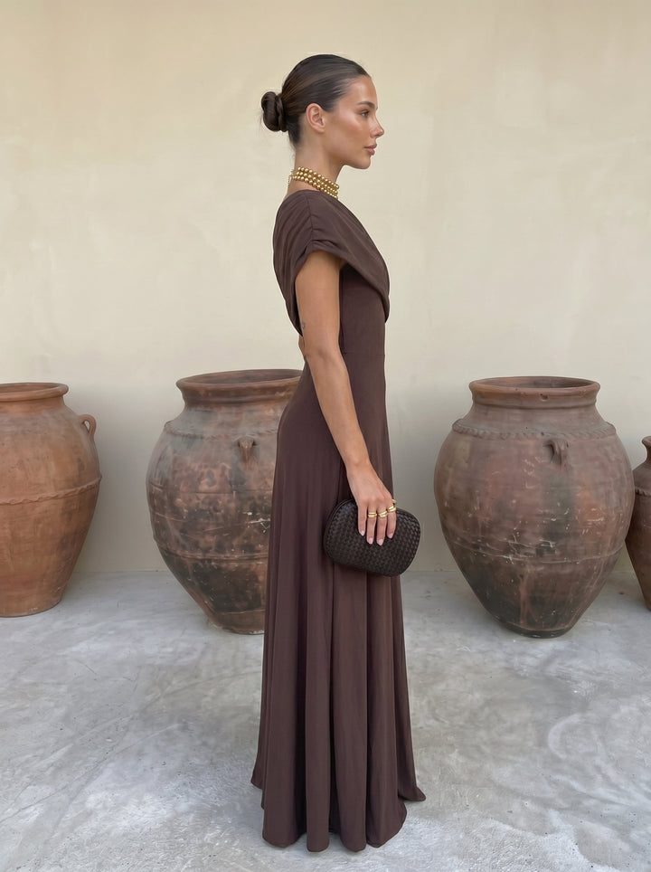 Women's elegant off-shoulder pleated maxi dress, comfortable & flowing occasion wear, available in brown.