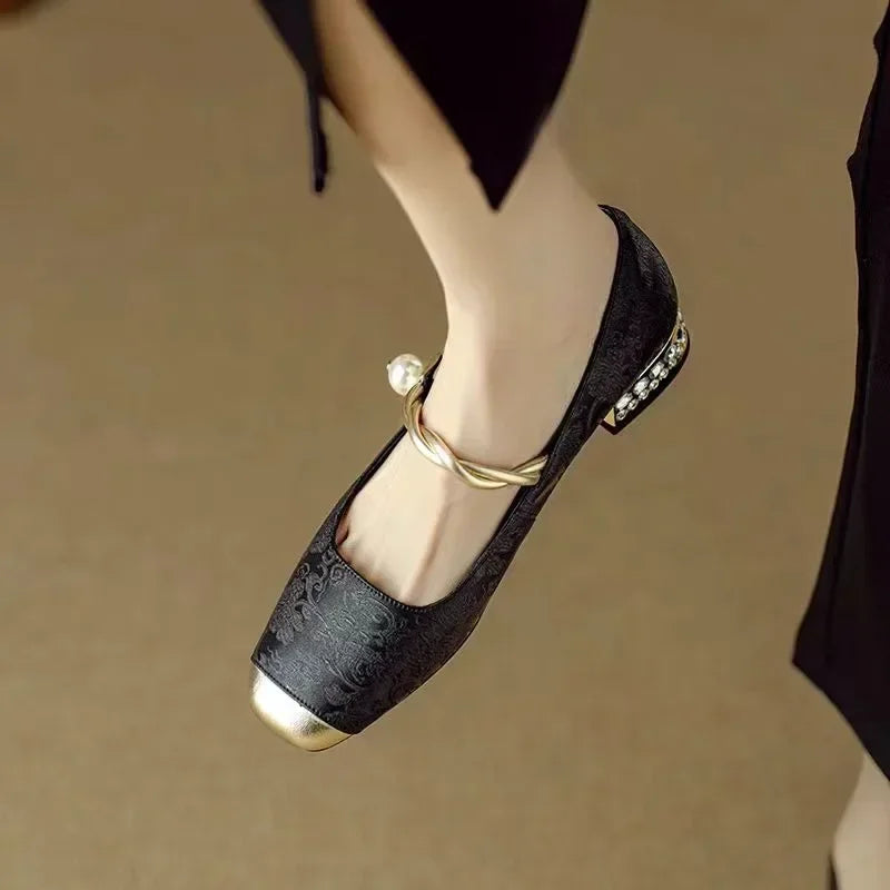 Side view of elegant women's Mary Jane heels with decorative pearl strap, retro style.