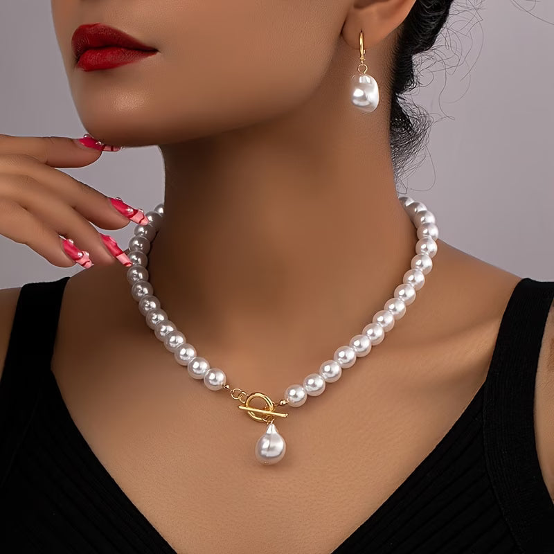 Elegant women's vintage pearl necklace & matching drop earrings set. Classic jewelry accessory.