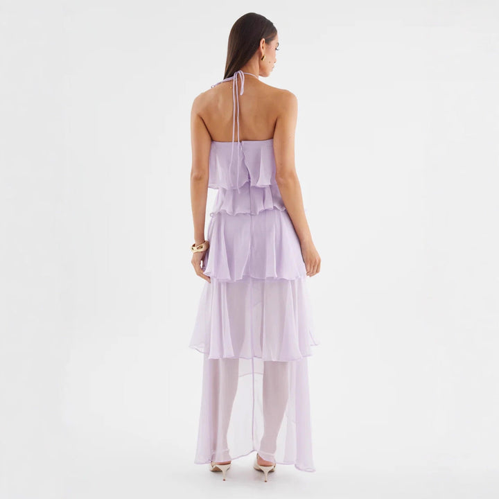 Full-length view of a chic women's halterneck ruffle maxi dress, ideal for an evening wedding guest.