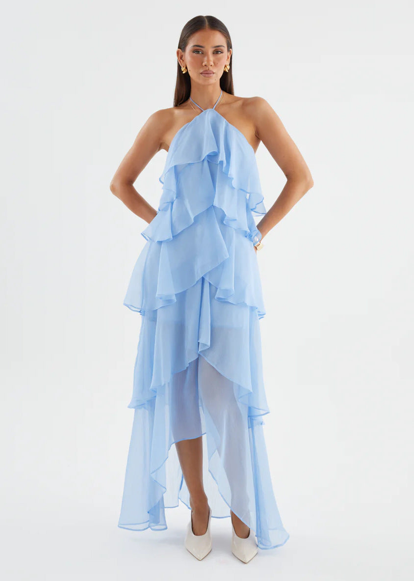 Model wearing a flowy women's formal halterneck maxi dress with delicate ruffles, great for evening events.