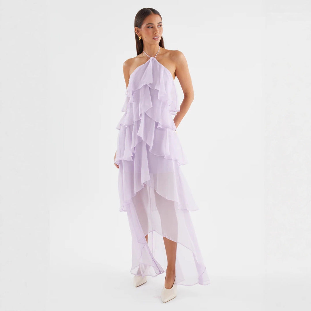 Close-up of the elegant halterneck and tiered ruffles on a women's wedding guest maxi dress.