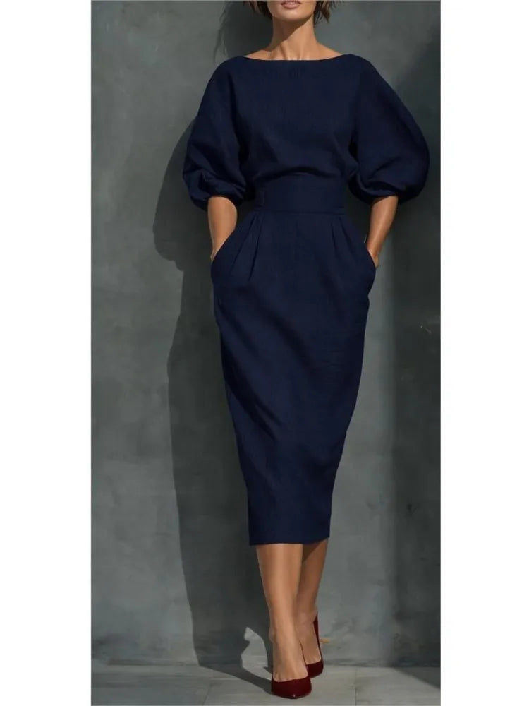 Chic women's elegant midi dress with flattering puff sleeves and a matching belt, suitable for formal wear.