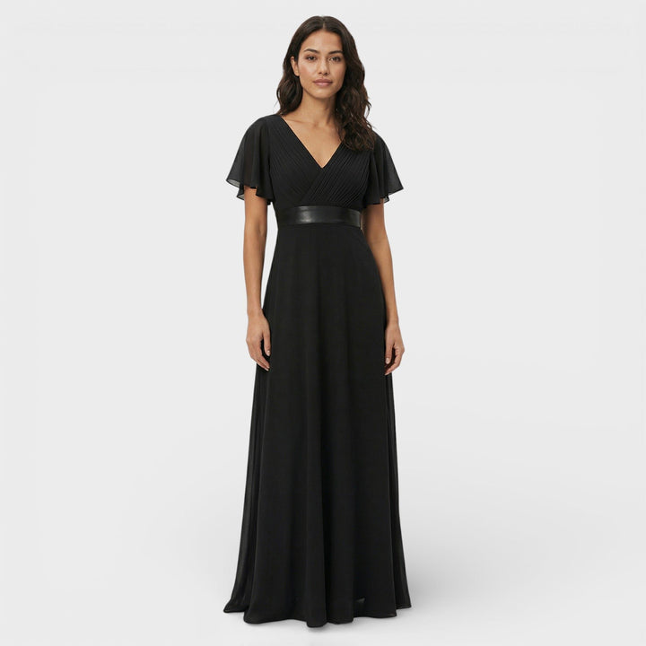 Women's wedding guest attire: a flowing pleated maxi dress with V-neck and elegant silhouette.