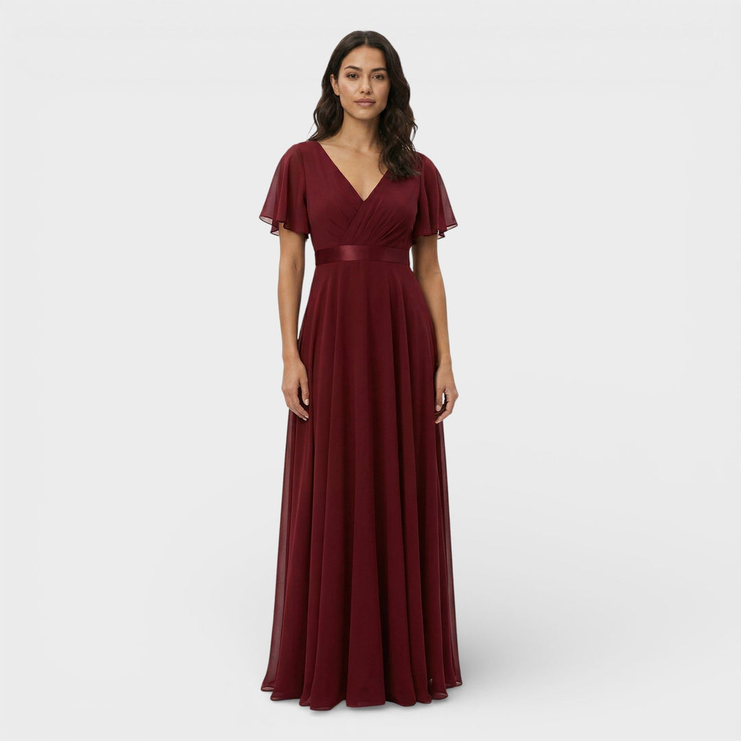 Formal women's special occasion dress, a long pleated maxi with V-neck and delicate flutter sleeves.