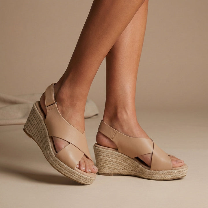 Stylish women's open-toe wedge sandals featuring a braided espadrille sole and secure ankle strap for resort fashion.