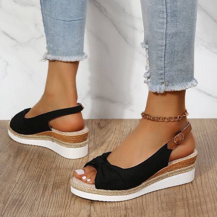Women's elegant knot detail wedge sandals for summer. Comfortable open-toe slingbacks, ideal for vacation & casual wear.