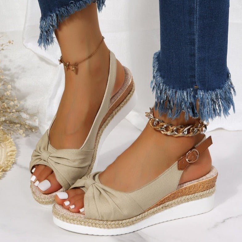 Chic women's wedge sandals featuring an elegant knot detail, open toe, & comfortable slingback design. Perfect for summer.