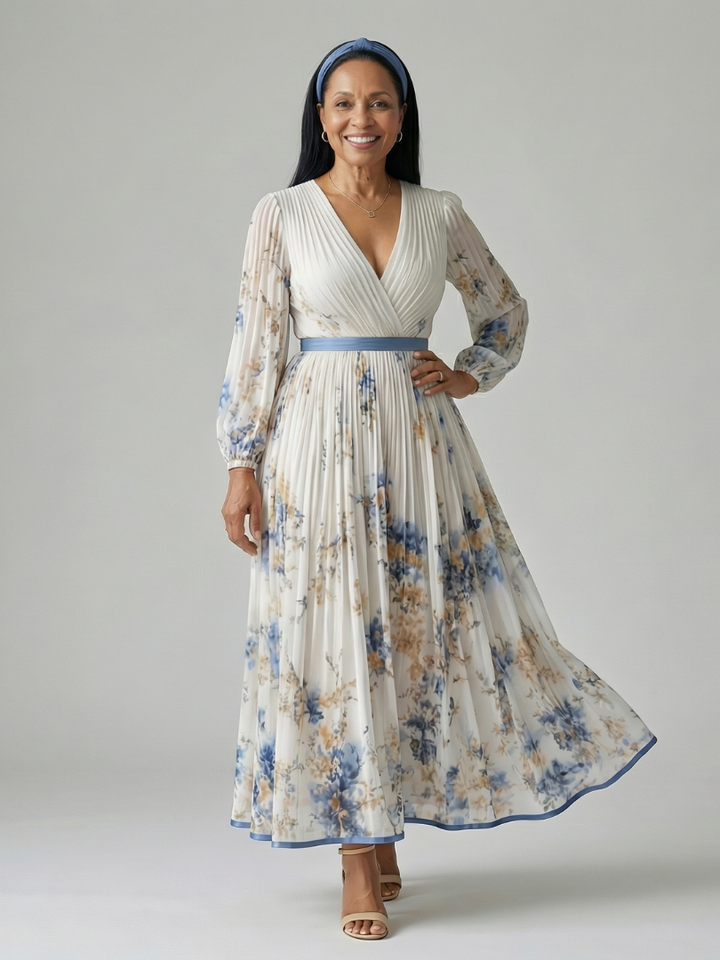 Close-up of a white floral print on an elegant women's midi wrap dress, showing delicate fabric and pleating.