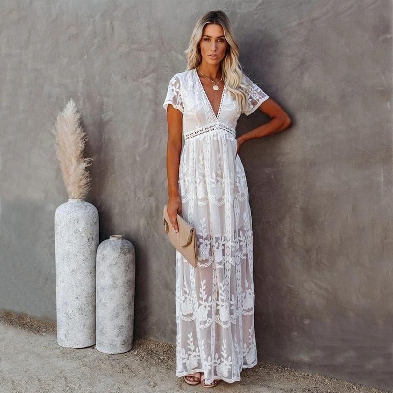 Elegant women's white maxi dress with romantic floral pattern, V-neck, and short sleeves for summer occasions.
