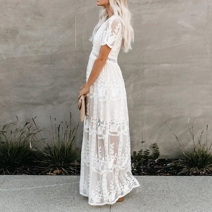 Flowy white patterned maxi dress for women, perfect for summer. Features a romantic design and V-neck.