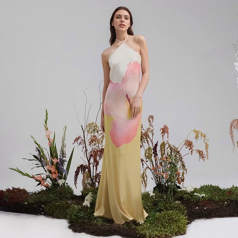 Flowing white one-shoulder floral maxi dress for women, ideal resort wear or an elegant evening event.