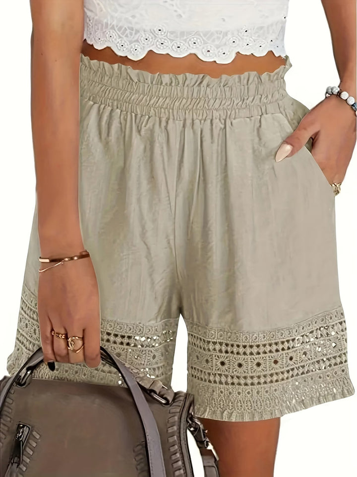 Elegant women's white shorts with delicate lace trim, stylish slant pockets. Perfect for summer chic & versatile wear.