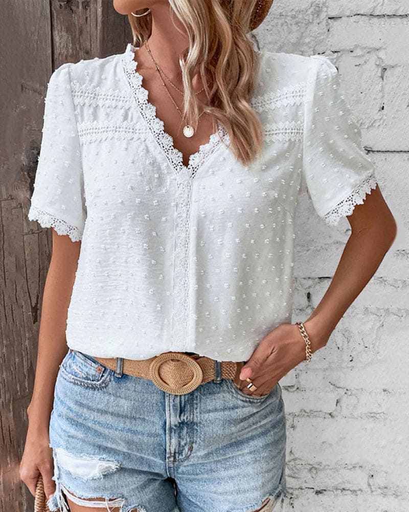 Elegant women's white V-neck blouse with delicate lace trim, Swiss dot fabric, and stylish short puff sleeves.
