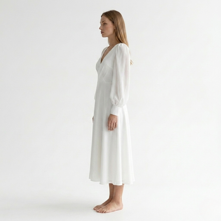 Chic women's white V-neck midi dress, featuring a flattering wrap style and graceful flared hem.