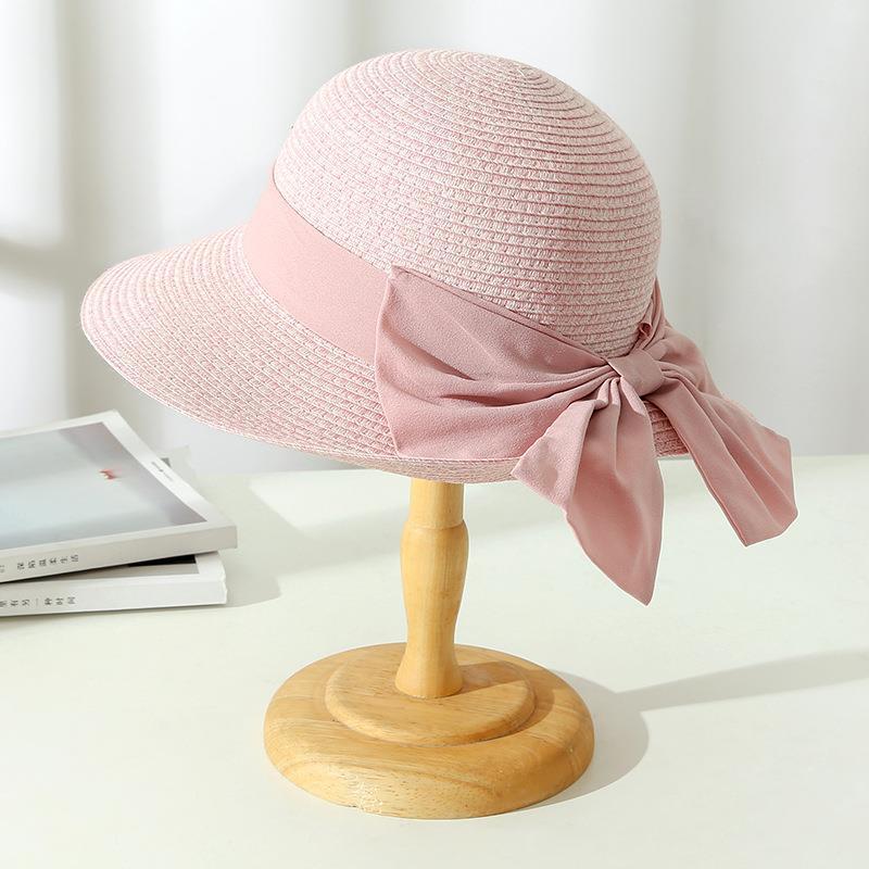Stylish wide brim straw beach hat for women, ideal for summer vacation and garden protection.