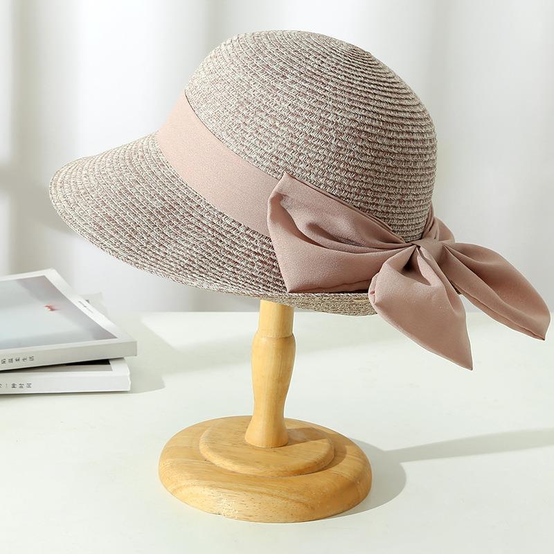 Chic women's wide brim straw sun hat for summer fashion, offering elegant sun protection.