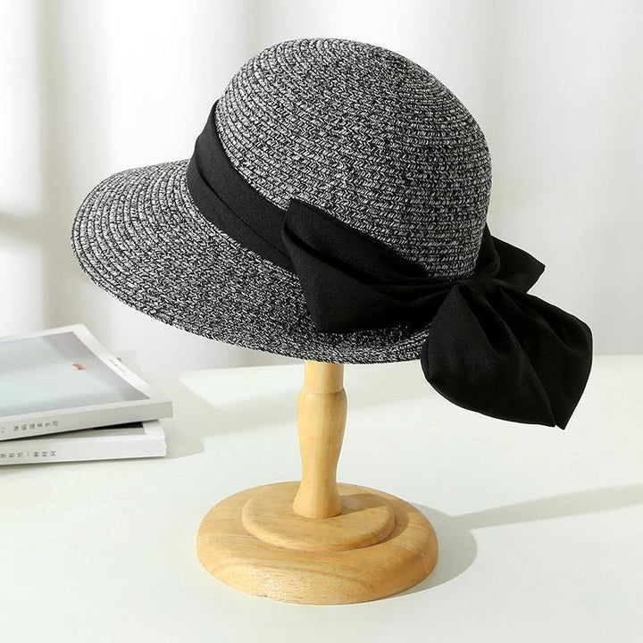 Classic wide brim straw sun hat for women, designed for stylish summer outdoor protection.