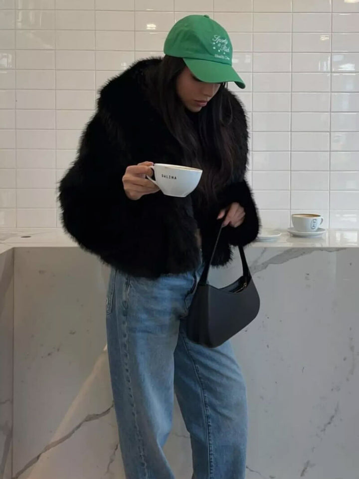 Full-length women's elegant classic wide lapel winter coat, a stylish and warm piece for cold weather.